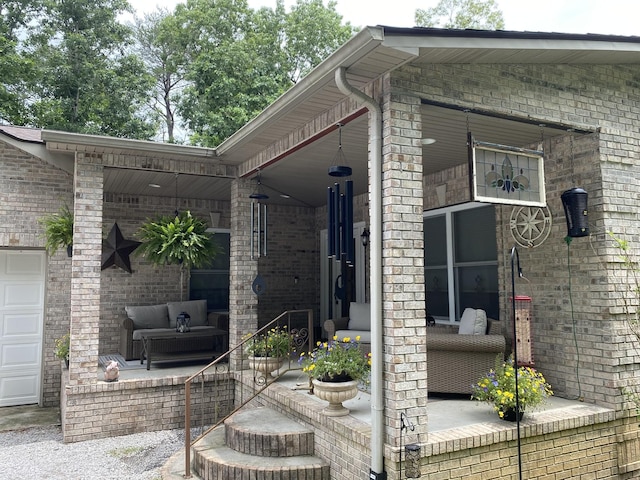 exterior space with brick siding, outdoor lounge area, and a porch