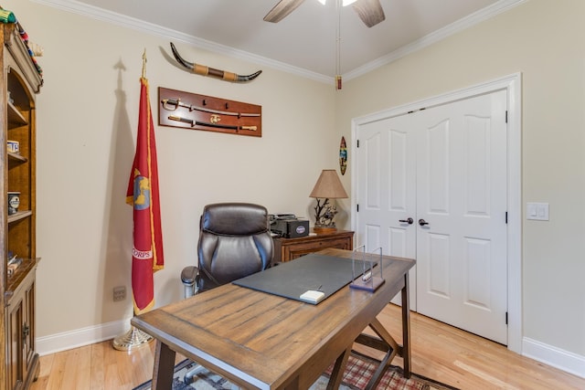 office space featuring crown molding, baseboards, ceiling fan, and light wood-style flooring