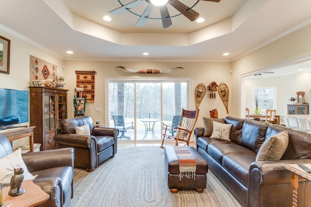 living area featuring plenty of natural light, recessed lighting, a raised ceiling, and ceiling fan