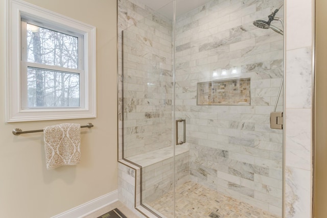 full bath featuring baseboards and a shower stall