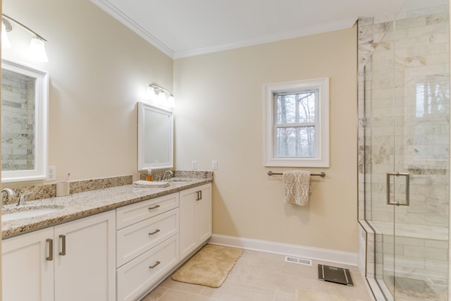 bathroom featuring visible vents, a sink, a shower stall, and ornamental molding