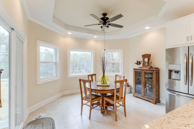 dining area featuring a ceiling fan, baseboards, recessed lighting, a tray ceiling, and visible vents