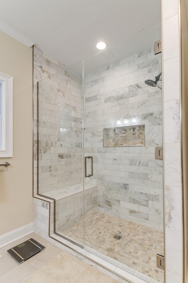 full bathroom featuring a shower stall, baseboards, tile patterned floors, ornamental molding, and recessed lighting