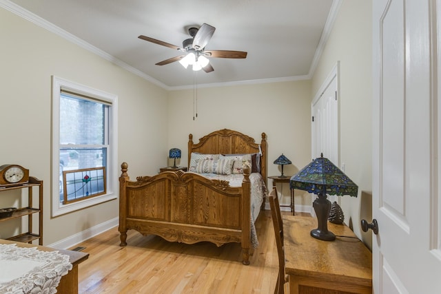 bedroom with light wood-type flooring, ornamental molding, baseboards, and ceiling fan