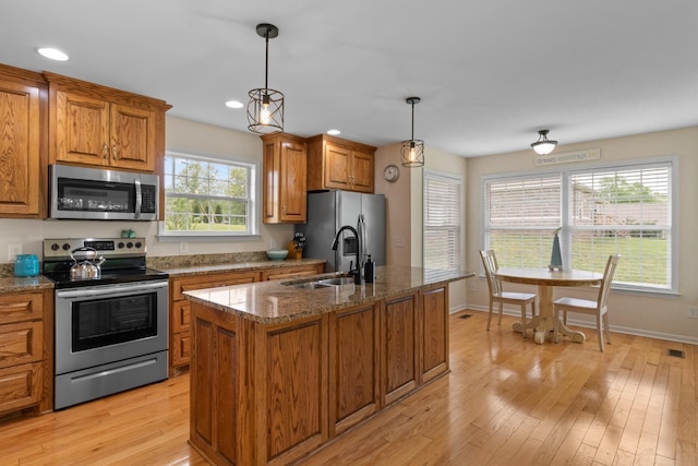 629 Natalie Ln, Spring Hill, TN 37174 - kitchen featuring light wood-type flooring, a sink, brown cabinets, and stainless steel appliances