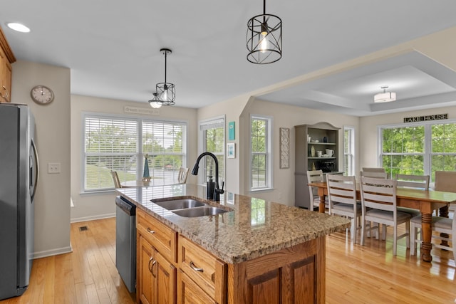 629 Natalie Ln, Spring Hill, TN 37174 - kitchen with appliances with stainless steel finishes, a healthy amount of sunlight, a sink, and light wood finished floors