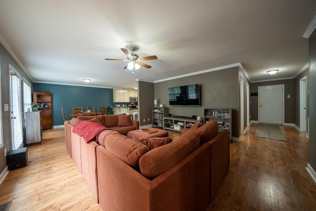 215 Desperado Ave, Pulaski, TN 38478 - living room featuring crown molding, baseboards, ceiling fan, and light wood-style flooring