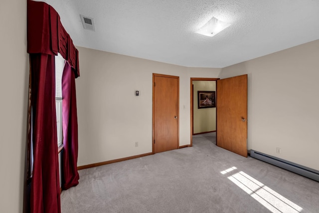 unfurnished bedroom featuring a textured ceiling, visible vents, baseboards, a baseboard radiator, and light carpet