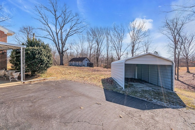 exterior space featuring a detached carport and aphalt driveway
