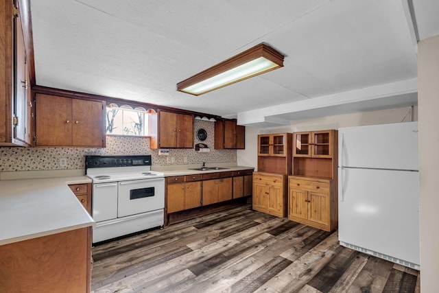 kitchen featuring dark wood-style flooring, open shelves, a sink, white appliances, and light countertops
