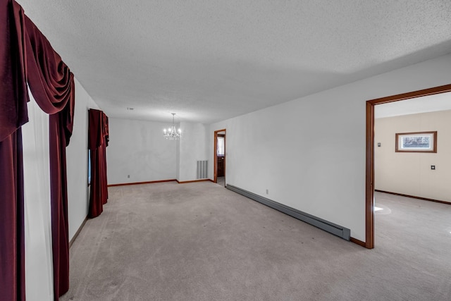 unfurnished room featuring light colored carpet, a textured ceiling, a chandelier, and baseboard heating