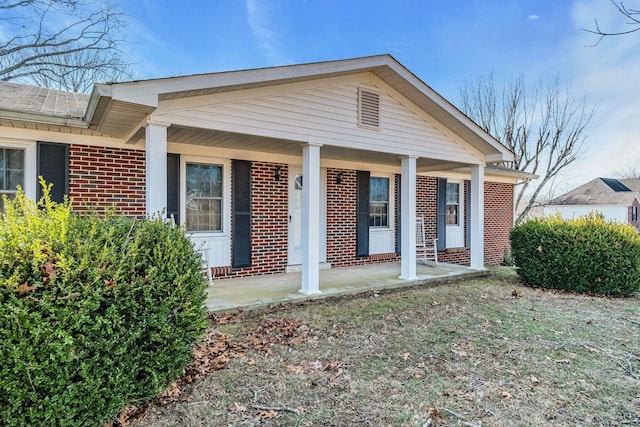view of front of property with covered porch and brick siding