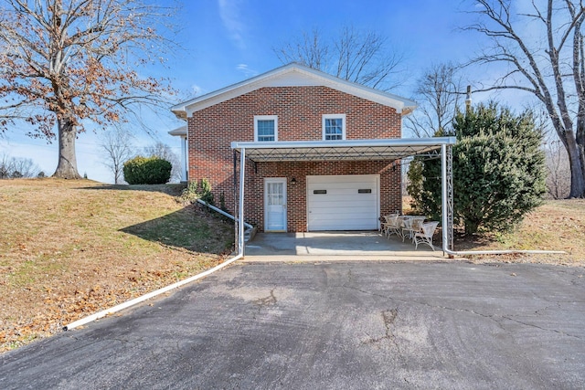 view of side of home featuring a lawn, brick siding, and driveway