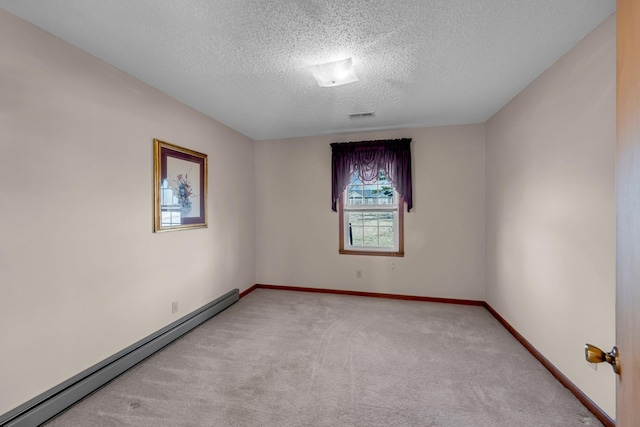 unfurnished room with light carpet, baseboard heating, a textured ceiling, baseboards, and visible vents