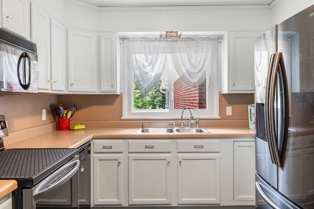 kitchen with white cabinets, a sink, black appliances, and light countertops