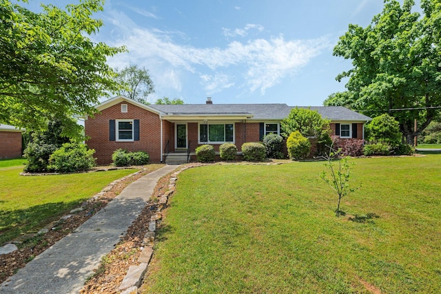 single story home featuring a front lawn and brick siding