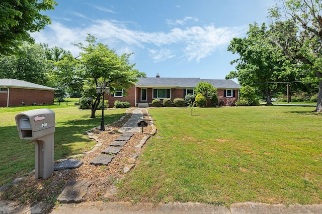 ranch-style house with brick siding and a front yard