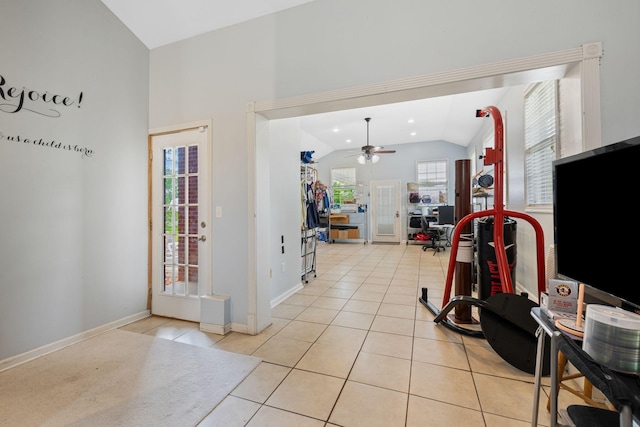 entrance foyer with baseboards, ceiling fan, light tile patterned floors, and lofted ceiling