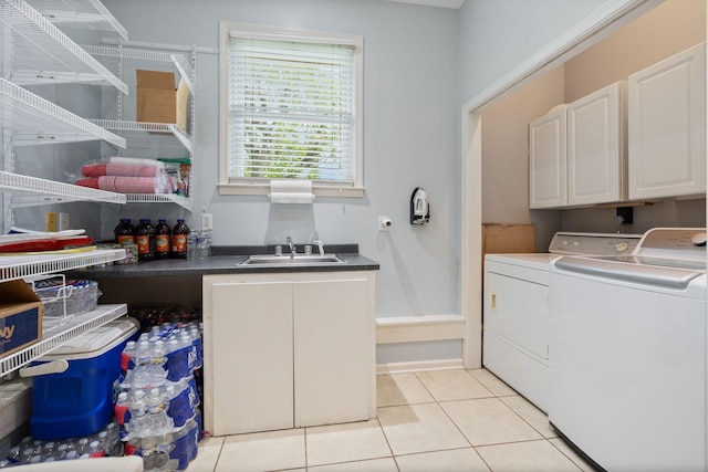 laundry room with a sink, cabinet space, independent washer and dryer, and light tile patterned floors