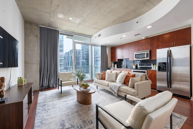 living room with recessed lighting, visible vents, and wood finished floors