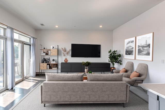 living area with visible vents, recessed lighting, and wood finished floors