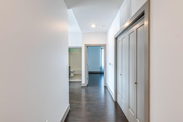 hall with baseboards and dark wood finished floors