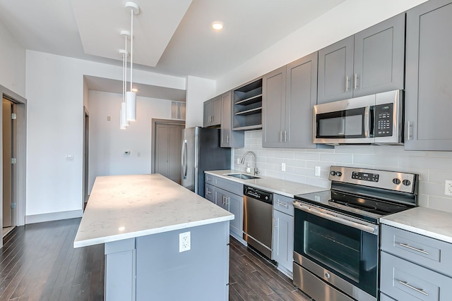 kitchen featuring gray cabinets, appliances with stainless steel finishes, a sink, and open shelves