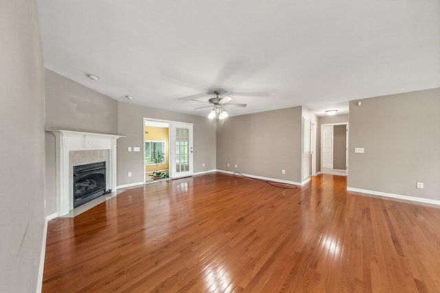 447 Canaan Rd, Columbia, TN 38401 - unfurnished living room featuring ceiling fan, baseboards, light wood-style floors, and a fireplace