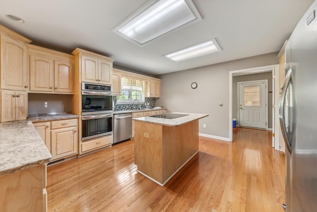 447 Canaan Rd, Columbia, TN 38401 - kitchen featuring stainless steel appliances, a center island, a sink, and light brown cabinets