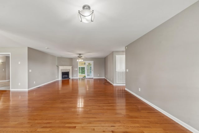 447 Canaan Rd, Columbia, TN 38401 - unfurnished living room featuring a ceiling fan, baseboards, light wood finished floors, and a fireplace