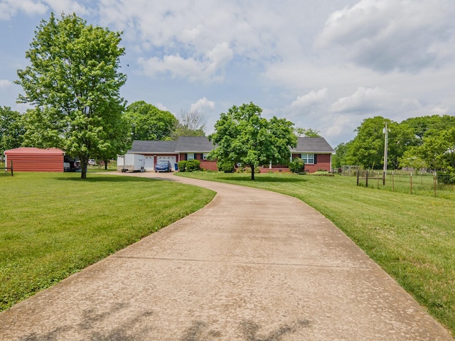 447 Canaan Rd, Columbia, TN 38401 - single story home with concrete driveway, fence, and a front yard