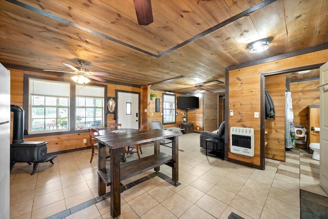 4231 Lylewood Rd, Indian Mound, TN 37079 - dining room with ceiling fan, heating unit, wood ceiling, and a wood stove