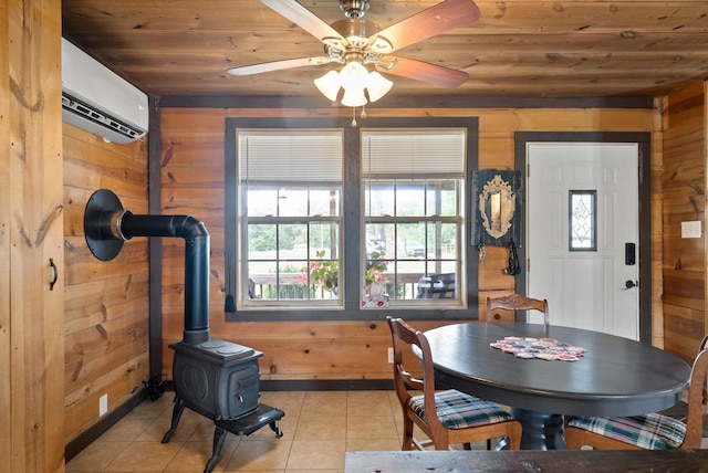 4231 Lylewood Rd, Indian Mound, TN 37079 - dining room featuring wooden ceiling, a wood stove, wood walls, and light tile patterned flooring