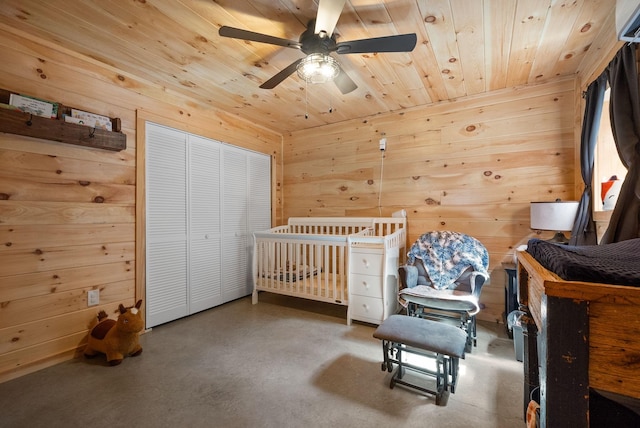 4231 Lylewood Rd, Indian Mound, TN 37079 - bedroom featuring wood walls, concrete floors, a ceiling fan, wooden ceiling, and a closet