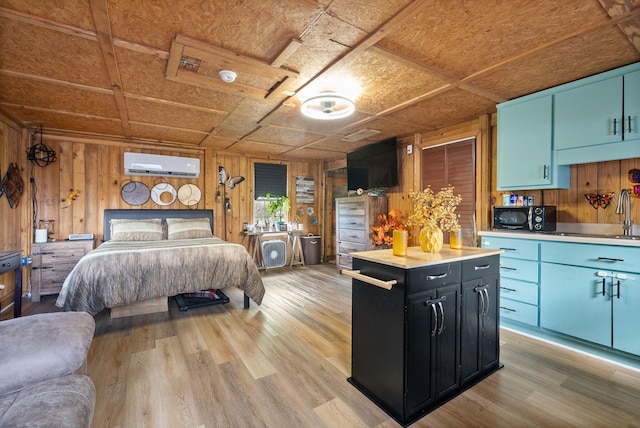 4231 Lylewood Rd, Indian Mound, TN 37079 - bedroom with wooden walls, a sink, light wood finished floors, a wall mounted air conditioner, and an ornate ceiling