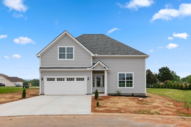 traditional-style home featuring a garage, driveway, and roof with shingles