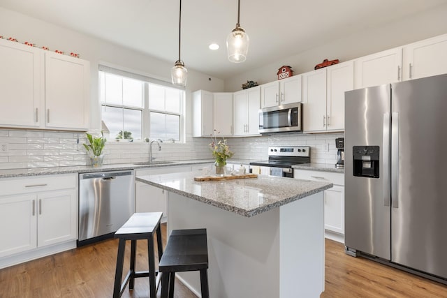 301 Harper Lndg Unit 301, Chapel Hill, TN 37034 - kitchen with stainless steel appliances, a breakfast bar area, white cabinets, and recessed lighting
