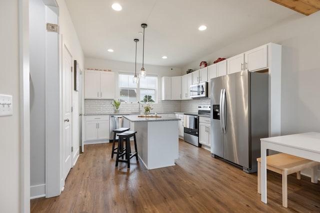 301 Harper Lndg Unit 301, Chapel Hill, TN 37034 - kitchen with appliances with stainless steel finishes, tasteful backsplash, white cabinetry, a kitchen island, and recessed lighting