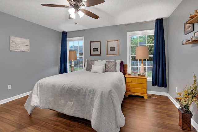 165 Daffodil Dr, Tullahoma, TN 37388 - bedroom featuring multiple windows, a textured ceiling, wood finished floors, baseboards, and a ceiling fan