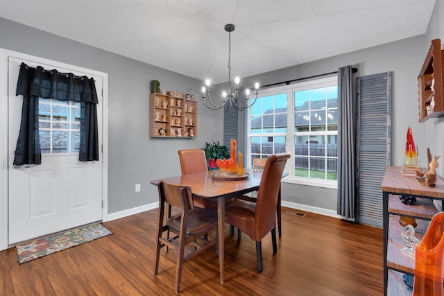 165 Daffodil Dr, Tullahoma, TN 37388 - dining space with dark wood-style floors, baseboards, a chandelier, and a textured ceiling