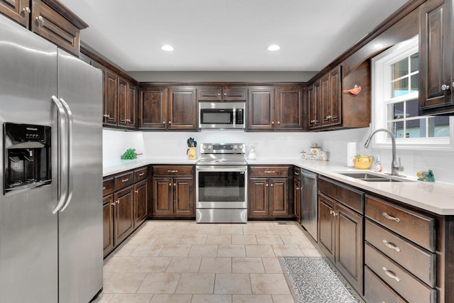 165 Daffodil Dr, Tullahoma, TN 37388 - kitchen featuring stainless steel appliances, a sink, dark brown cabinetry, light countertops, and recessed lighting