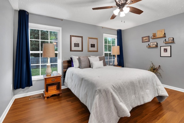 165 Daffodil Dr, Tullahoma, TN 37388 - bedroom with wood finished floors, baseboards, a textured ceiling, and a ceiling fan