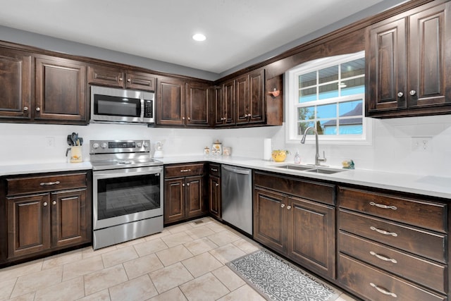 165 Daffodil Dr, Tullahoma, TN 37388 - kitchen featuring appliances with stainless steel finishes, a sink, dark brown cabinetry, and recessed lighting