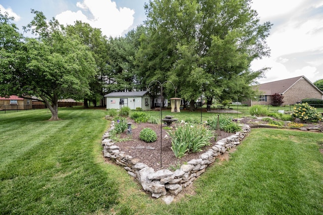view of yard with fence and an outbuilding