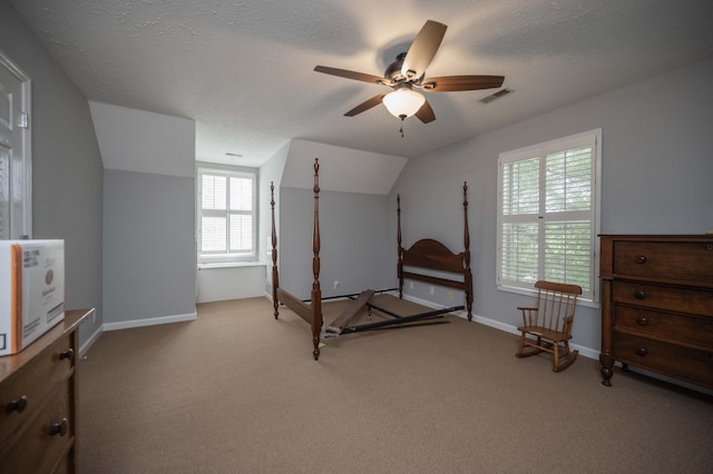 bedroom with carpet flooring, a ceiling fan, visible vents, and vaulted ceiling