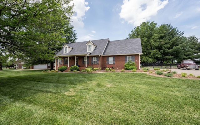 cape cod-style house with a porch, roof with shingles, brick siding, fence, and a front lawn