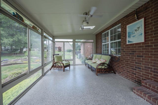 sunroom featuring an outdoor living space and ceiling fan