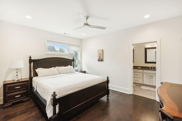 bedroom with a sink, baseboards, dark wood-style floors, connected bathroom, and recessed lighting
