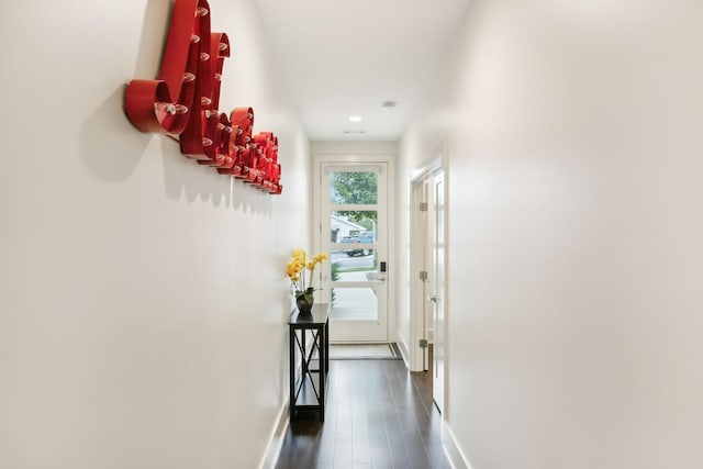 hallway with baseboards, recessed lighting, and wood finished floors