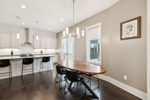 dining space with recessed lighting, dark wood-style flooring, baseboards, and a chandelier